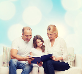 Image showing happy family with book at home