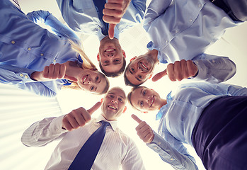 Image showing smiling group of businesspeople standing in circle