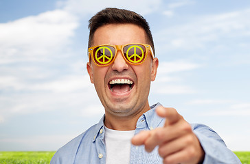Image showing face of laughing man in green peace sunglasses