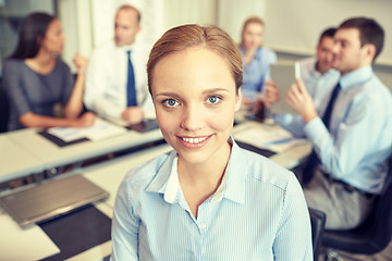 Image showing group of smiling businesspeople meeting in office