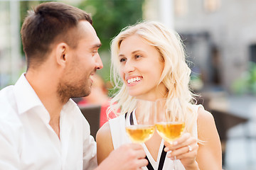 Image showing happy couple clinking glasses at restaurant lounge