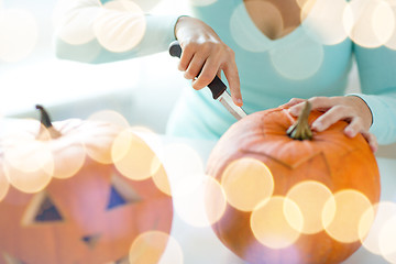 Image showing close up of woman with pumpkins at home