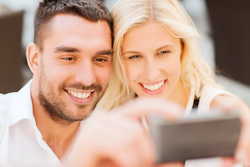 Image showing happy couple taking selfie with smartphone 