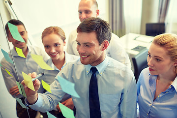 Image showing smiling business people with marker and stickers