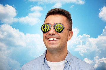 Image showing face of smiling man in green peace sunglasses