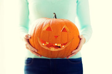 Image showing close up of woman with pumpkins at home