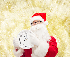 Image showing man in costume of santa claus with clock