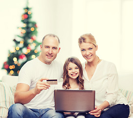 Image showing happy family with laptop computer