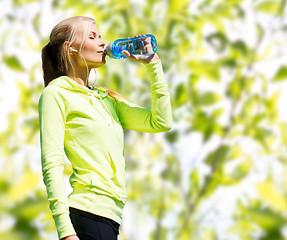 Image showing woman drinking water after doing sports outdoors