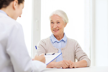 Image showing doctor with clipboard and senior woman at hospital