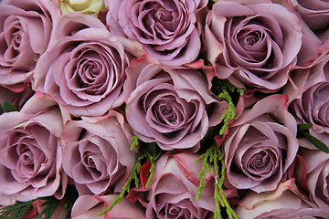 Image showing Purple roses in a wedding arrangement