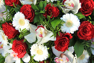 Image showing Cymbidium orchids, red roses and white gerberas