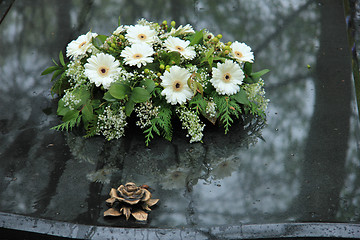 Image showing Funeral flowers on a tomb