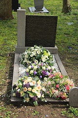 Image showing Sympathy flowers on a grave