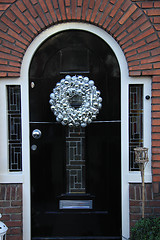 Image showing Silver christmas wreath with decorations on a door