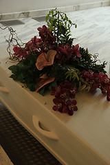 Image showing Funeral flowers on a casket