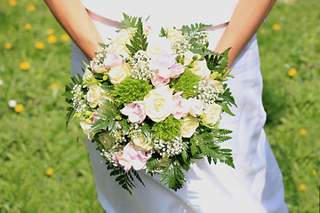 Image showing Bride holding bouquet