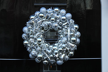 Image showing Silver christmas wreath with decorations on a door