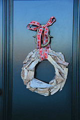 Image showing Classic christmas wreath with decorations on a door