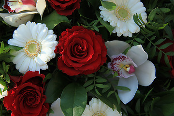 Image showing Cymbidium orchids, red roses and white gerberas