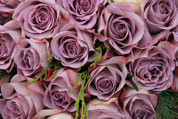 Image showing Purple roses in a wedding arrangement