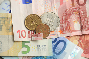 Image showing torn euro note and vintage greek coins