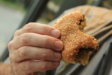 Image showing Man holding a hamburger