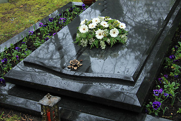 Image showing Funeral flowers on a tomb