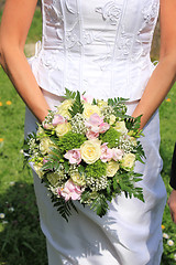 Image showing Bride holding bouquet