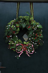 Image showing Classic christmas wreath with decorations on a door