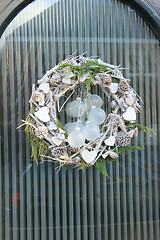 Image showing christmas wreath with decorations on a door