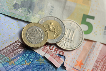 Image showing torn euro note and vintage greek coins