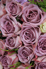 Image showing Purple roses in a wedding arrangement