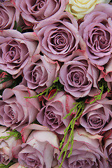 Image showing Purple roses in a wedding arrangement