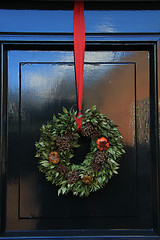 Image showing Classic christmas wreath with decorations on a door
