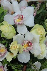 Image showing Cymbidium orchids and white roses in bridal bouquet