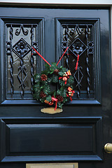 Image showing Classic christmas wreath with decorations on a door