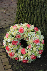 Image showing Sympathy wreath near tree