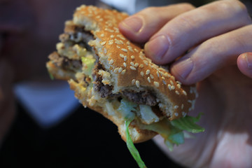 Image showing Man holding a hamburger