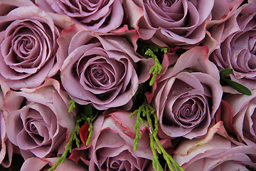 Image showing Purple roses in a wedding arrangement