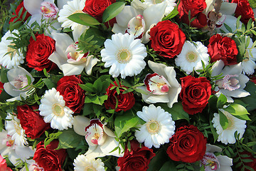 Image showing Cymbidium orchids, red roses and white gerberas