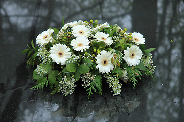 Image showing Funeral flowers on a tomb