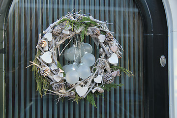 Image showing christmas wreath with decorations on a door