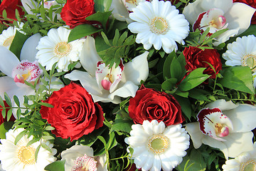 Image showing Cymbidium orchids, red roses and white gerberas