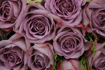 Image showing Purple roses in a wedding arrangement