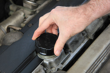 Image showing Checking engine oil