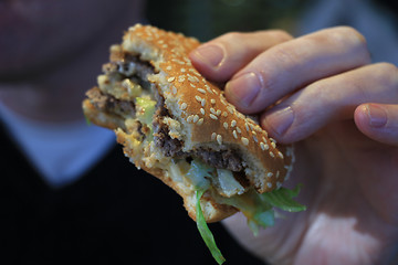 Image showing Man holding a hamburger