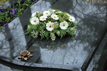 Image showing Funeral flowers on a tomb