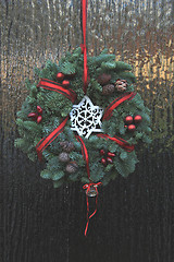 Image showing Classic christmas wreath with decorations on a door