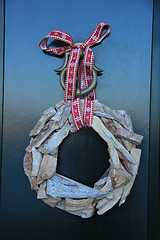 Image showing Classic christmas wreath with decorations on a door